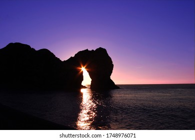 Durdle Door Sunrise Through Arch