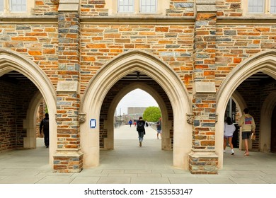 Durham, NC, USA - April 16, 2022: Students Walking Through The Vaulted Stone Archway Of Duke University Chapel In Durham North Carolina USA. Duke Is A Private Top Ranked Research University In NC.