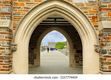 Durham, NC, USA - April 16, 2022: Students Walking Through The Vaulted Stone Archway Of Duke University Chapel In Durham North Carolina USA. Duke Is A Private Top Ranked Research University In NC.