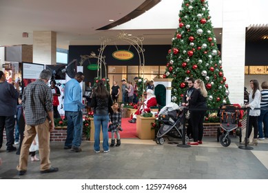 Durham, NC/United States- 12/16/2018: Parents Line Up With Their Children To Take Pictures With Santa Claus Inside A Mall.