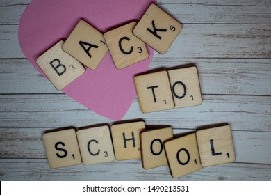 Durham, UK - 18 August 2019: Back To School Concept. Back To School Spelled Out On Scrabble Letters On A Rustic Wooden Background. Preparation For Going Back To School After The Summer Holidays.