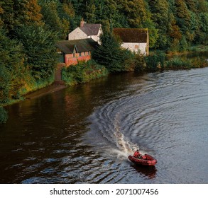 Durham,UK, 8th October 2021.Durham School Boat Club Building And Red Rescue Emergency Response Boat On The River Wear.