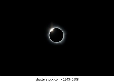 During the 2012 total solar eclipse the moon has completely covered the sun, leaving only a ring of light where the sun has been eclipsed.  A diamond ring appears as the moon slips off the sun.