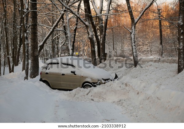 During the
accident, the car drove off a slippery winter road. A broken car
after an accident in a snowdrift. The driver lost control of the
car on a slippery road in icy
conditions