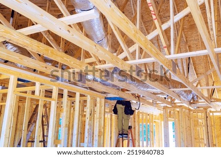 During construction, silver insulation ventilation HVAC pipes were installed from ceiling to roof