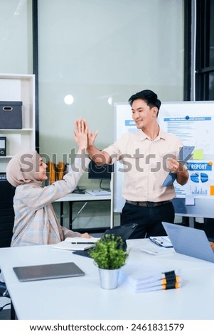 During a dynamic presentation, diverse professionals engage in teamwork, celebrating success with high fives, while discussing financial strategies illustrated on a whiteboard.