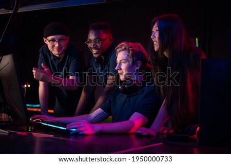 During an esports training session, a team of boys and girls sort out the latest game and smile