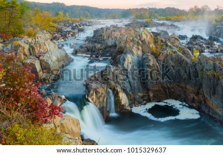 During the fall season Great Falls displays beautiful colors along the ripaians boundaries of the Potomac River near Washington DC. This view is from an overlook at Great Falls Park, VA