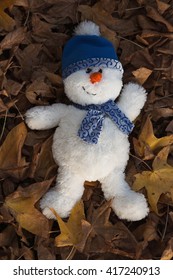 During The Golden Hour Of The Day, A Snowman Has Fun Playing In The Autumn Leaves, Making Snow Angels And Escaping The Chill Of Winter. Vertical, Flat Layout, Copy Space.