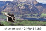 During holiday taking aerial cableway to Stanserhorn Mountain seeing beautiful autumn season view of the Stans valley floor, Lake Lucerne, Engelberg valley and Obwalden in Switzerland