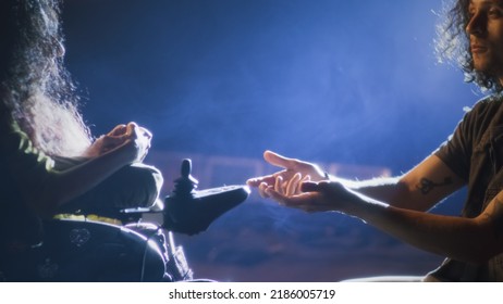 During a rehearsal of a romantic performance with a director, an actor on his knees singing a song to a actress with disability who use electric wheelchair on a stage illuminated by a spotlight - Powered by Shutterstock