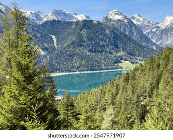 During a spring hiking exercise it is always worth to spot though the green forest nature towards to the Achensee lake and the beautiful turquoise colored water