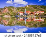 Durnstein, Austria. Wachau Valley on Danube River, beautiful village with blue church, water reflection.