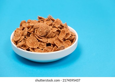 Durum Wheat Flakes - Quick Breakfast Cereal On A Plate On A Blue Background, Space For Text
