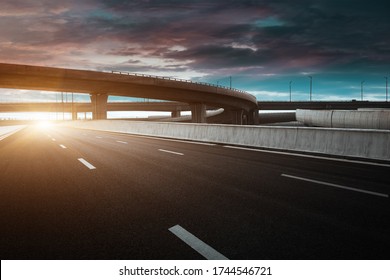 Dusk colored clouds in the background, highway overpass curved approach bridge  - Powered by Shutterstock