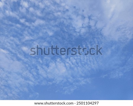 Dusk and dramatic moody stratus clouds float in the evening sky