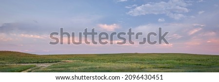 dusk over green prairie - Pawnee National Grassland in Colorado, late spring or early summer scenery, panoramic web banner