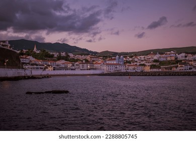 Dusk in the sea and lowlight historical architecture of Angra do Heroísmo in the background at sunset, Terceira - Azores PORTUGAL