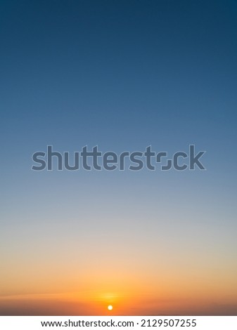 Dusk sky vertical with colorful orange sunlight and dark blue in the evening on twilight 