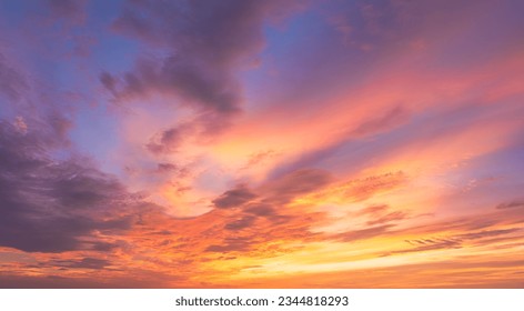 Dusk, Sunset Sky Clouds in the Evening with colorful Orange, Yellow, Pink and red sunlight and Dramatic storm clouds on twilight sky, Landscape horizon Golden sky nature Summer Background 