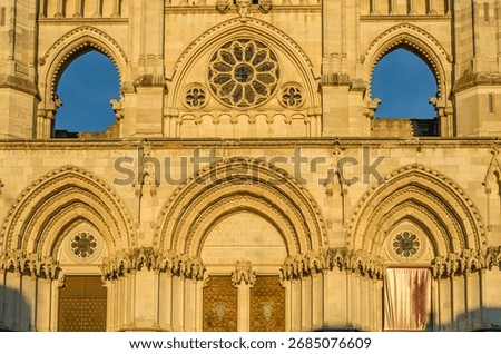 Dusk view of the Gothic Cathedral of Saint Mary and Saint Julian, with facade illuminated by warm light. It is a Catholic cathedral in the town of Cuenca, Castilla La Mancha, Spain