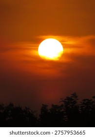 dusky view of the setting sun during sunset in the evening