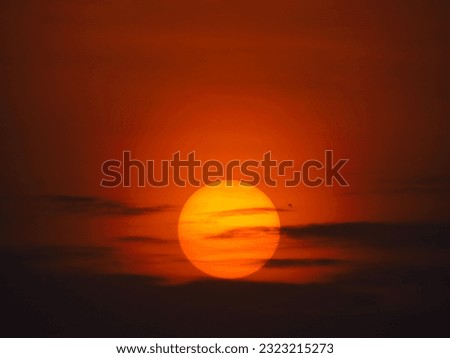 dusky view of the setting sun during sunset in the evening