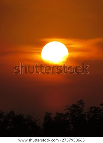 dusky view of the setting sun during sunset in the evening