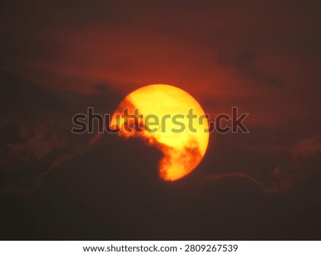 Dusky view of the setting sun during sunset in the evening