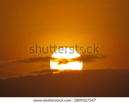 Dusky view of the setting sun during sunset in the evening