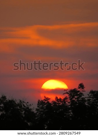 Dusky view of the setting sun during sunset in the evening