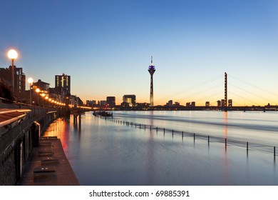 Dusseldorf During High Tide Of Rhine River In The Evening