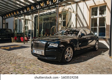 Dusseldorf, Germany - JULY 24, 2019: Full-size Luxury Car Rolls-Royce Ghost Agaist Hotel Entrance