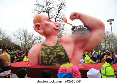 DUSSELDORF, GERMANY - MARCH 3, 2014: Rose Monday Carnival Theme Float About The Annexation Of The Crimea With Russian Leader Vladimir Putin Showing His Muscle On March 3, 2014 In Dusseldorf.