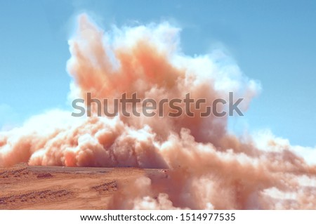 Dust clouds after the detonator blasting on the mining site 