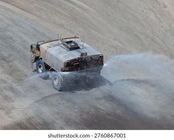 Dust control process using huge 30,000-gallon tankers on open-pit mine roads