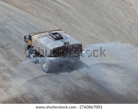 Dust control process using huge 30,000-gallon tankers on open-pit mine roads