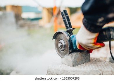 Dust from cutting concrete stone with an electric grinder - diamond blade for fast and accurate sawing - construction site