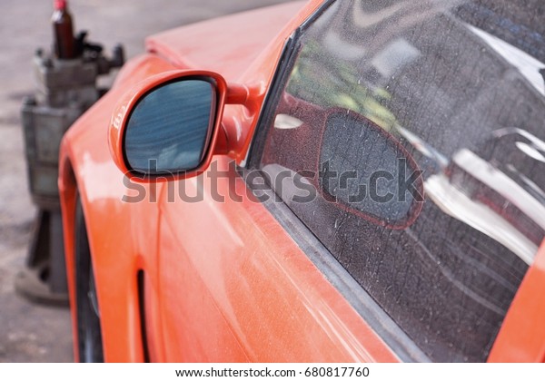 The dust\
in the garage window in a garage waiting for maintenance without\
care. Dust stick behind the rear\
glass.