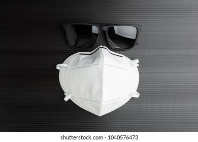 Dust Mask And Sun Glasses On Black Background. In Dry Season Has Smoke Issue In Northern Thailand, So People Need Dust Mask For Protect Themself.