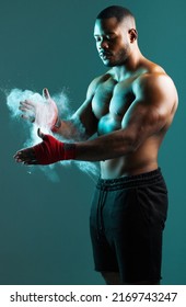 Dust Off Yesterday, Make Way For Today. Shot Of A Young Man Dusting His Hands With Chalk Against A Studio Background.