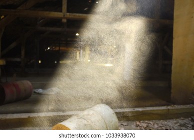 Dust Particles Bounce Off One Another Illuminated By Beam Of Sunlight From An   Old Wooden Attic Window 