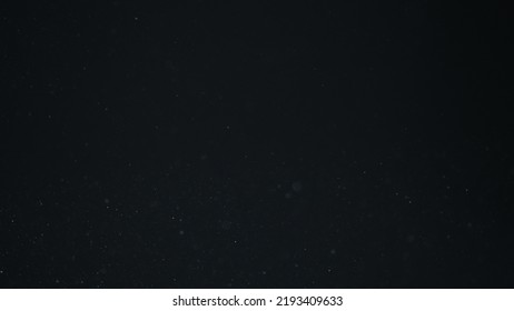 Dust Particles Float In Sunlight On Black Background, Wide Photo