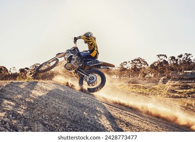 Dust, race and man on dirt bike in desert with adventure, adrenaline and speed in competition, Extreme sport, trick and athlete on off road motorcycle for challenge, power or danger on action course