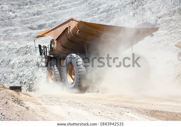 Dust raised by a\
dump truck at a copper\
mine.