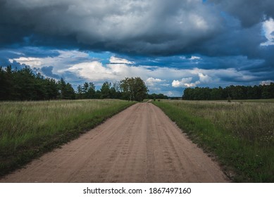 Dust Road Among Meadows In Masuria Region Of Poland