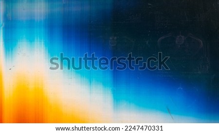 Dust scratch overlay. Light flare. Old film texture. Orange blue white rainbow color glow defect dirt stains on dark abstract empty space background.
