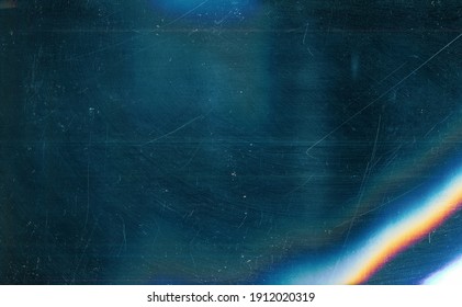 Dust scratches overlay. Old film effect. Blue distressed faded glass with smeared dirt stains colorful rainbow lens flare design. - Shutterstock ID 1912020319