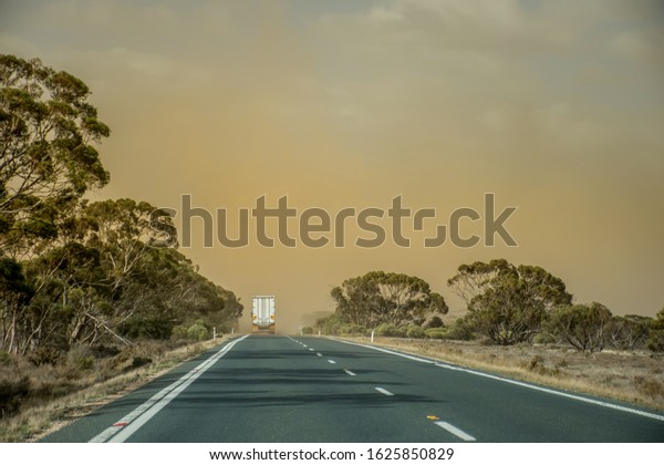 A dust storm on the road\
near Mildura, Australia. Dust particles in the air cause low\
visibility