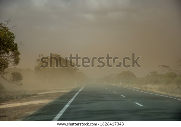 A dust storm on the road\
near Mildura, Australia. Dust particles in the air cause low\
visibility
